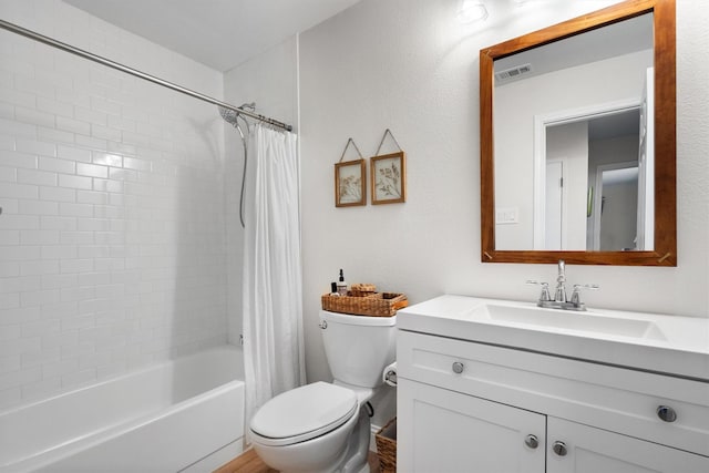 bathroom with toilet, vanity, and shower / tub combo