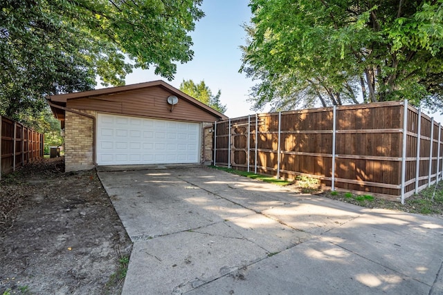 detached garage featuring fence
