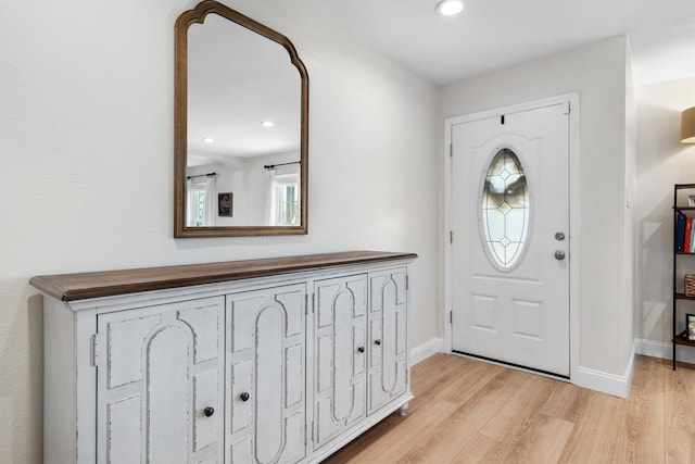 entryway featuring light wood-type flooring, baseboards, and recessed lighting