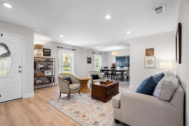 living room with light wood finished floors and recessed lighting