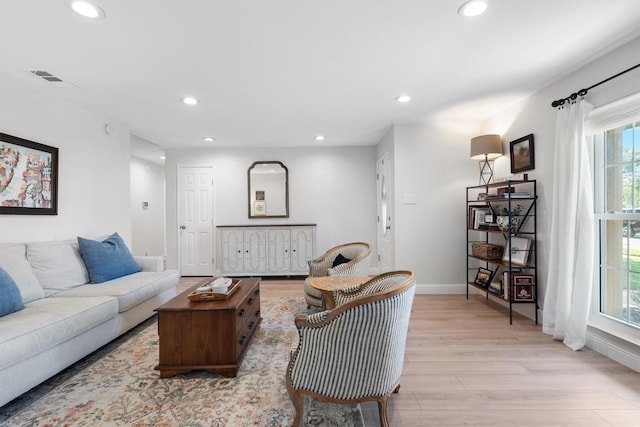 living area with recessed lighting, light wood finished floors, and baseboards
