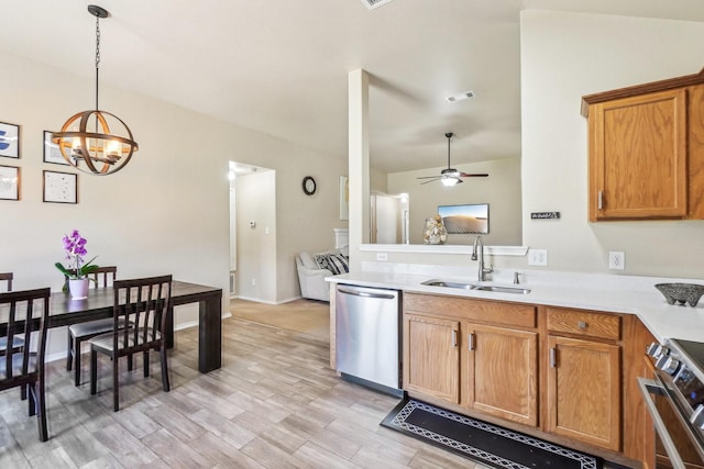 5530 Exeter Dr, Prosper, TX 75078 - kitchen with stainless steel appliances, a sink, ceiling fan, light countertops, and a chandelier