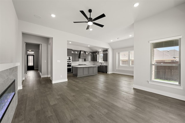 329 Lovett Ln, Burleson, TX 76028 - unfurnished living room with ceiling fan, dark wood-style floors, a tiled fireplace, baseboards, and recessed lighting