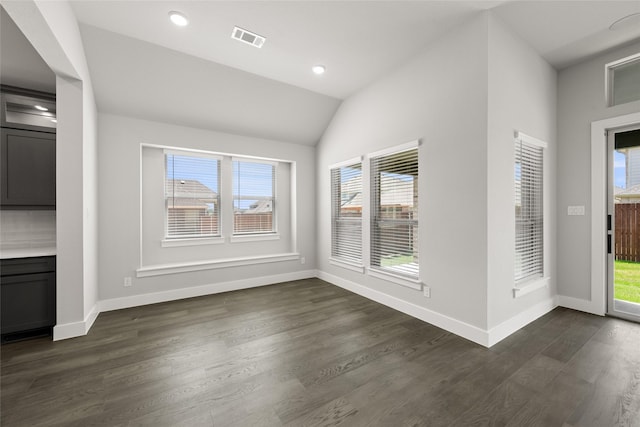 329 Lovett Ln, Burleson, TX 76028 - unfurnished dining area featuring healthy amount of natural light, baseboards, dark wood-style flooring, vaulted ceiling, and recessed lighting