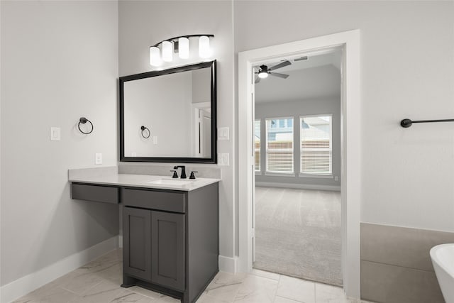 329 Lovett Ln, Burleson, TX 76028 - full bath with marble finish flooring, a freestanding tub, vanity, baseboards, and ceiling fan