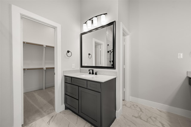 329 Lovett Ln, Burleson, TX 76028 - full bathroom with marble look tiles, vanity, baseboards, and a walk in closet
