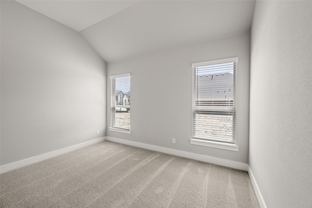329 Lovett Ln, Burleson, TX 76028 - empty room with baseboards, light colored carpet, and vaulted ceiling