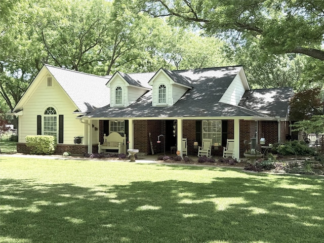 3335 Hedrick Ln, Princeton, TX 75407 - new england style home with a porch, a front lawn, and brick siding