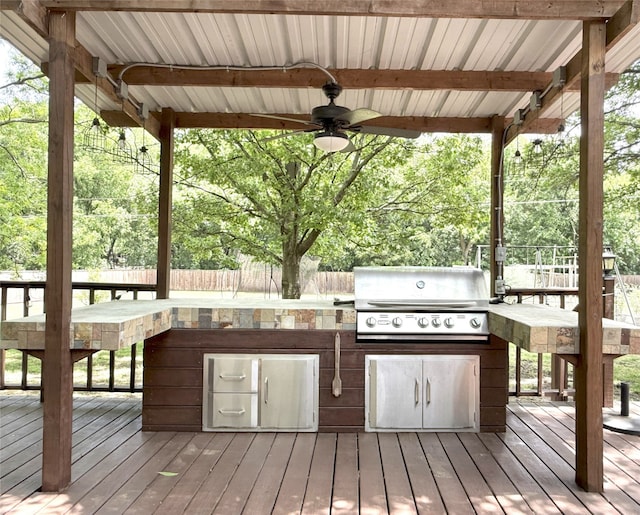 3335 Hedrick Ln, Princeton, TX 75407 - wooden terrace with ceiling fan, a grill, an outdoor kitchen, and fence