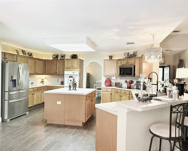 3335 Hedrick Ln, Princeton, TX 75407 - kitchen with stainless steel appliances, light countertops, a kitchen island, a peninsula, and a kitchen breakfast bar