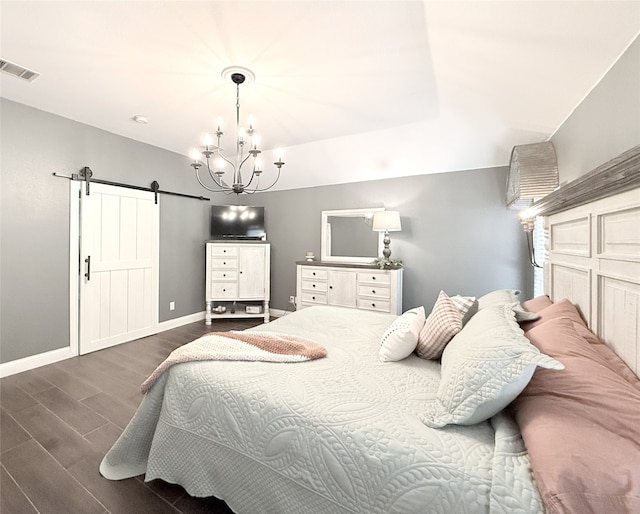 3335 Hedrick Ln, Princeton, TX 75407 - bedroom featuring a barn door, wood finished floors, baseboards, a chandelier, and vaulted ceiling