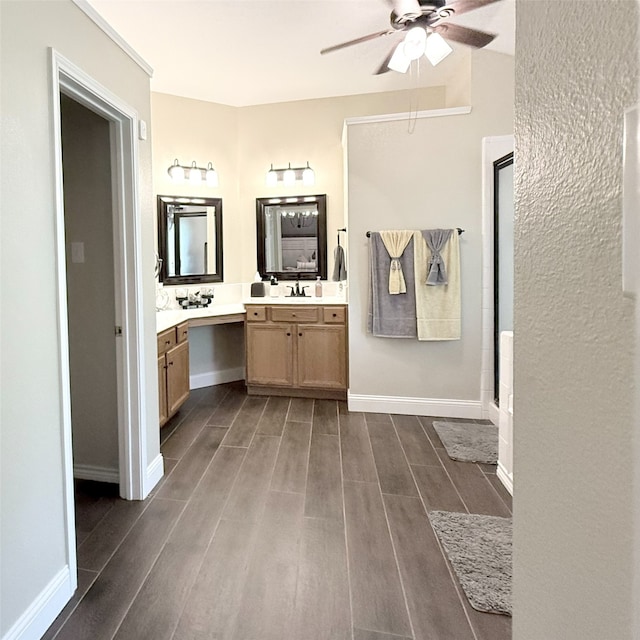 3335 Hedrick Ln, Princeton, TX 75407 - full bathroom featuring wood finished floors, ceiling fan, vanity, an enclosed shower, and baseboards