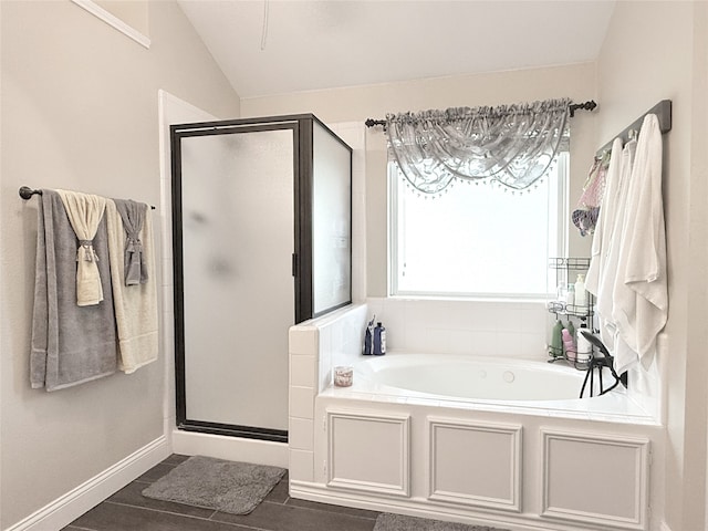 3335 Hedrick Ln, Princeton, TX 75407 - full bathroom with a garden tub, a stall shower, lofted ceiling, and baseboards