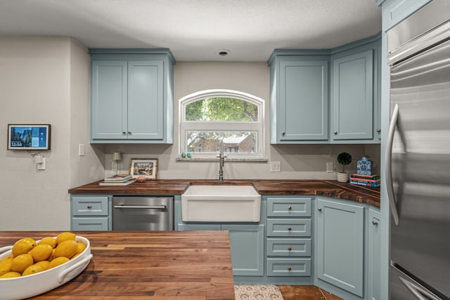 3304 Bowden Hill Ln N, Colleyville, TX 76034 - kitchen featuring butcher block counters, appliances with stainless steel finishes, and a sink