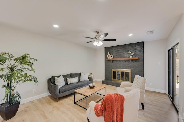 3 Collins Ct, Richardson, TX 75081 - living area with light wood-style floors, a ceiling fan, a brick fireplace, and recessed lighting