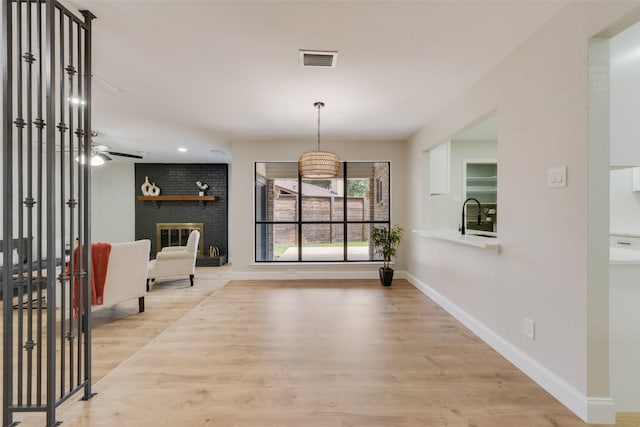 3 Collins Ct, Richardson, TX 75081 - foyer entrance with light wood-style floors, a fireplace, and recessed lighting