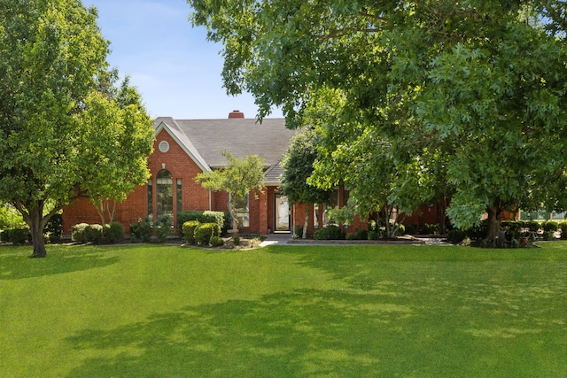 110 Man O War Ln, Fairview, TX 75069 - view of front of house with a front lawn, brick siding, a chimney, and a shingled roof