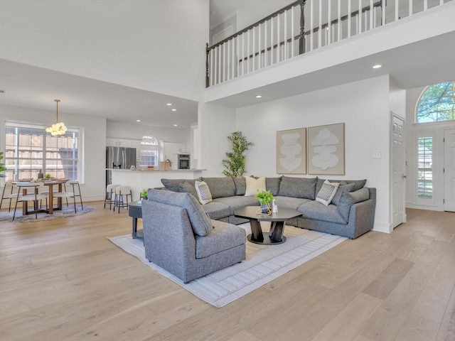 5904 Sandhills Cir, Plano, TX 75093 - living area with light wood-type flooring, a high ceiling, baseboards, and recessed lighting