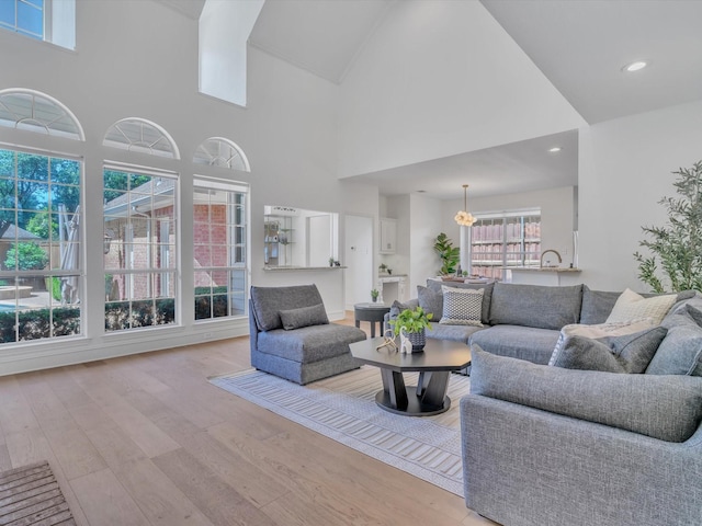 5904 Sandhills Cir, Plano, TX 75093 - living area with wood finished floors, high vaulted ceiling, and recessed lighting