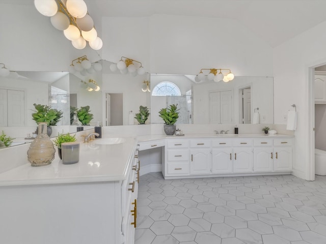 5904 Sandhills Cir, Plano, TX 75093 - bathroom with vaulted ceiling, a walk in shower, and vanity