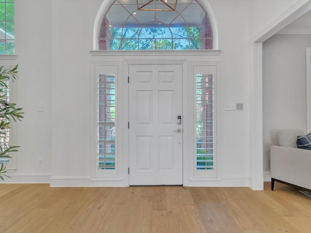 5904 Sandhills Cir, Plano, TX 75093 - entryway featuring light wood finished floors, baseboards, and a chandelier