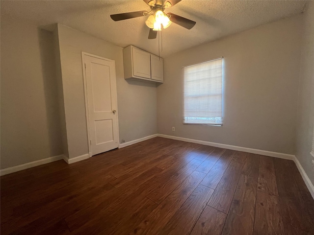 2722 Locust Ave, Dallas, TX 75216 - unfurnished room with a textured ceiling, dark wood-style flooring, ceiling fan, and baseboards
