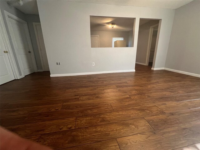 2722 Locust Ave, Dallas, TX 75216 - spare room featuring dark wood-style flooring and baseboards