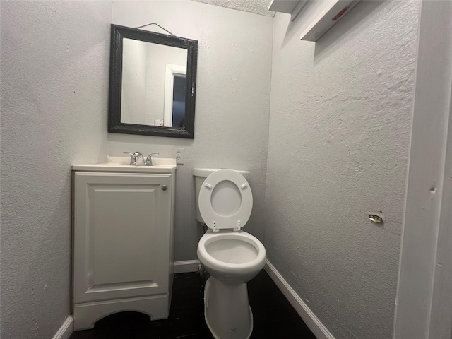 2722 Locust Ave, Dallas, TX 75216 - half bathroom featuring baseboards, toilet, and vanity