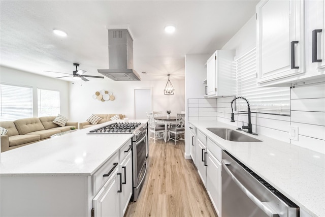 10816 Joaquin Dr, Dallas, TX 75228 - kitchen featuring a sink, stainless steel appliances, ventilation hood, white cabinetry, and ceiling fan