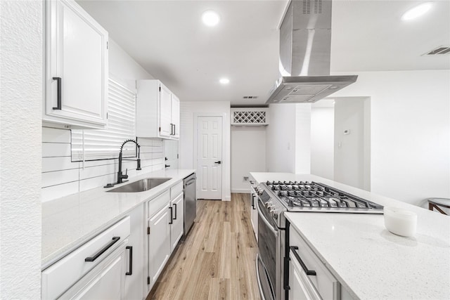 10816 Joaquin Dr, Dallas, TX 75228 - kitchen featuring a sink, stainless steel appliances, wall chimney range hood, light wood-style flooring, and recessed lighting