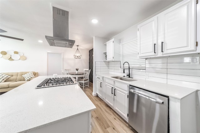 10816 Joaquin Dr, Dallas, TX 75228 - kitchen with stainless steel dishwasher, a sink, gas cooktop, island exhaust hood, and white cabinets