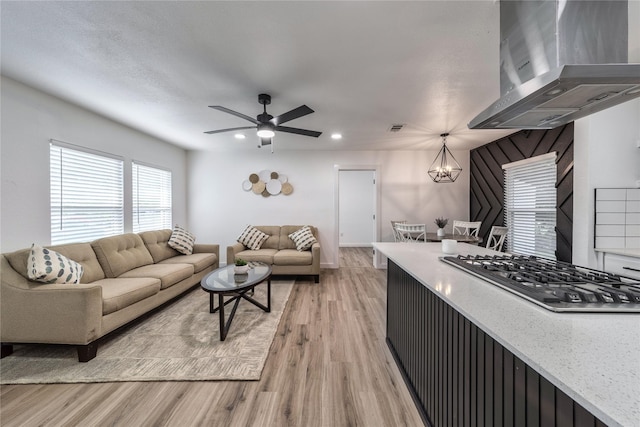 10816 Joaquin Dr, Dallas, TX 75228 - living area featuring light wood-style flooring, a ceiling fan, a chandelier, and recessed lighting