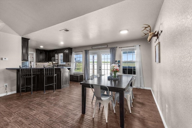 2250 Poolville Cut Off Rd, Poolville, TX 76487 - dining area with dark wood-style floors, a textured wall, french doors, baseboards, and a textured ceiling