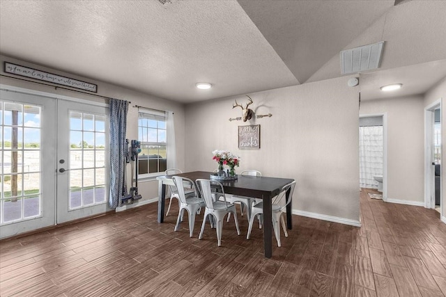 2250 Poolville Cut Off Rd, Poolville, TX 76487 - dining room featuring dark wood-style flooring, baseboards, french doors, and a textured ceiling