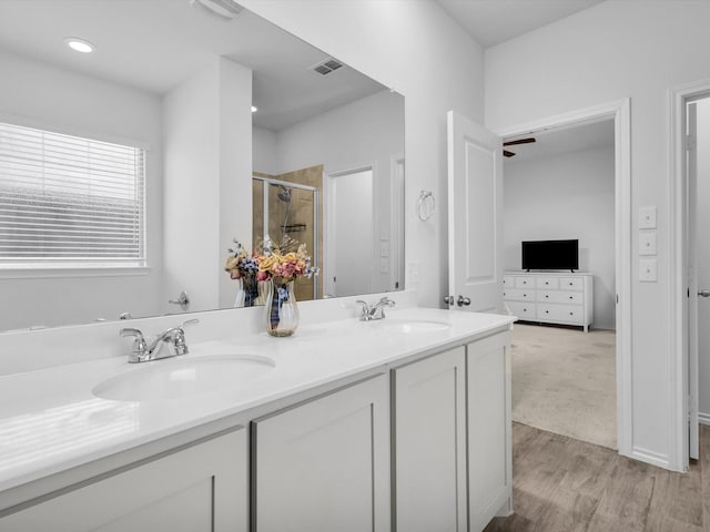 1705 Wayne Ln, Celina, TX 75009 - full bathroom with double vanity, a shower stall, wood finished floors, and ensuite bathroom