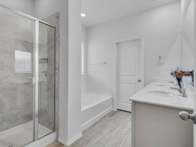 1705 Wayne Ln, Celina, TX 75009 - bathroom featuring a shower stall, a bath, double vanity, and wood finished floors