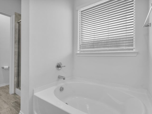 1705 Wayne Ln, Celina, TX 75009 - bathroom featuring a bath, a shower stall, and wood finished floors