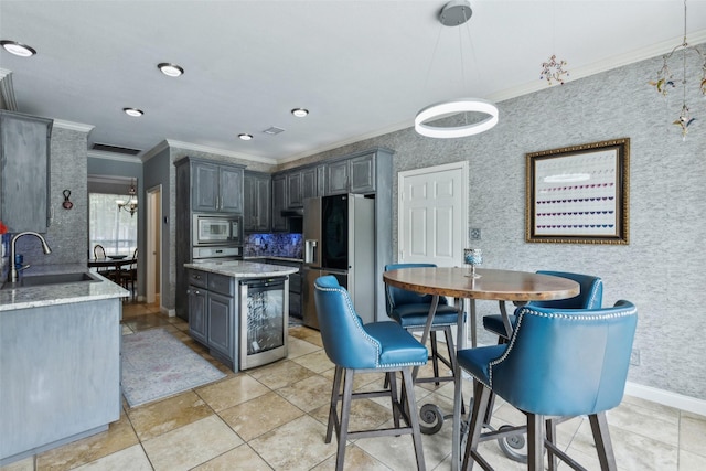 119 Palomino Ct, Shady Shores, TX 76208 - kitchen with a sink, stainless steel appliances, ornamental molding, beverage cooler, and light stone counters