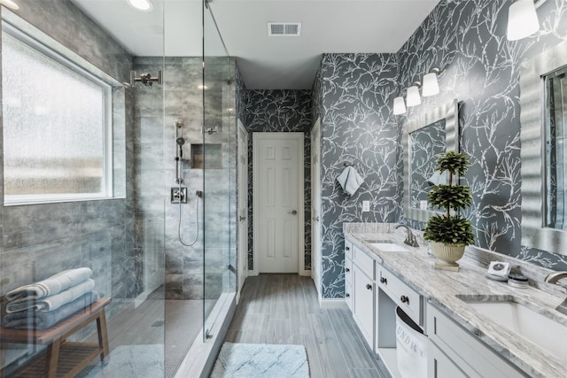 119 Palomino Ct, Shady Shores, TX 76208 - full bath with wallpapered walls, a stall shower, double vanity, and wood finished floors