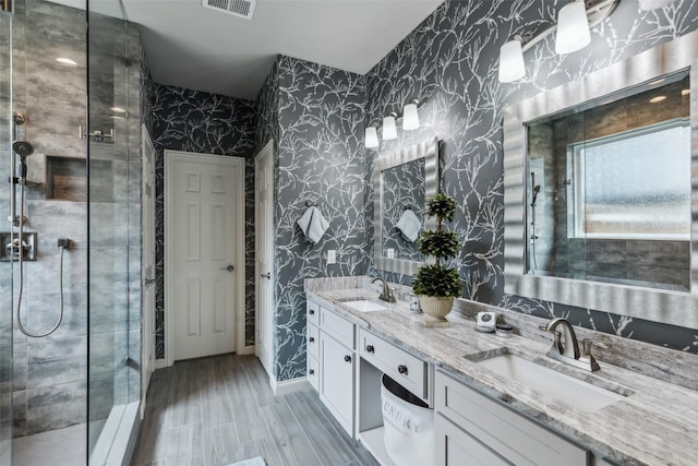 119 Palomino Ct, Shady Shores, TX 76208 - full bath featuring wallpapered walls, a shower stall, double vanity, and wood finished floors