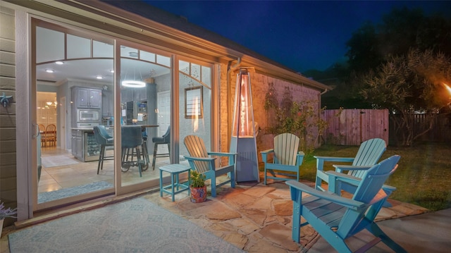 119 Palomino Ct, Shady Shores, TX 76208 - patio at night featuring fence
