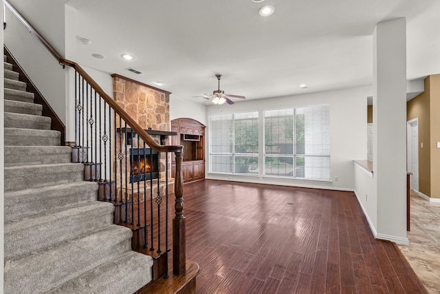 1205 Wynne Dr, Garland, TX 75044 - stairway with ceiling fan, wood finished floors, baseboards, recessed lighting, and a fireplace