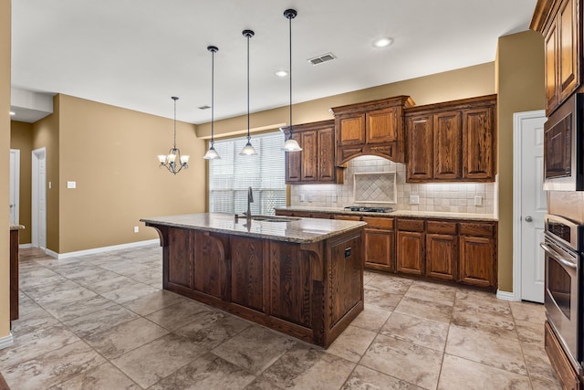 1205 Wynne Dr, Garland, TX 75044 - kitchen with oven, decorative backsplash, built in microwave, dark stone countertops, and a chandelier