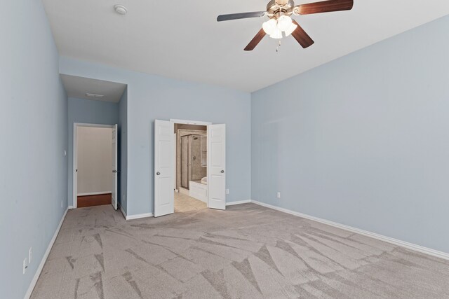 1205 Wynne Dr, Garland, TX 75044 - unfurnished bedroom with light colored carpet, baseboards, ensuite bathroom, and a ceiling fan