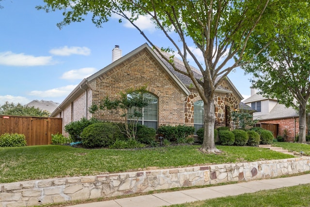 1205 Wynne Dr, Garland, TX 75044 - view of front facade featuring brick siding and a chimney