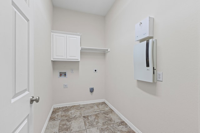 1205 Wynne Dr, Garland, TX 75044 - laundry room featuring hookup for an electric dryer, baseboards, hookup for a washing machine, cabinet space, and stone finish flooring