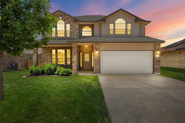 11108 Buzzard Gulch Dr, Waco, TX 76708 - traditional home with an attached garage, brick siding, central AC unit, a yard, and driveway