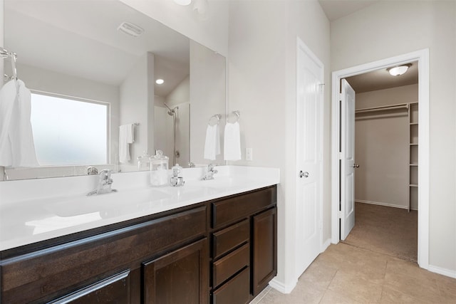 11108 Buzzard Gulch Dr, Waco, TX 76708 - full bath featuring a shower, double vanity, tile patterned floors, a spacious closet, and baseboards