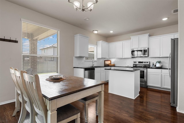 11108 Buzzard Gulch Dr, Waco, TX 76708 - kitchen with stainless steel appliances, a sink, decorative backsplash, a chandelier, and dark wood-type flooring