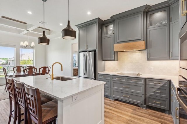 10136 Braided Briar Ln, Waco, TX 76712 - kitchen featuring freestanding refrigerator, a sink, gray cabinetry, under cabinet range hood, and black electric stovetop